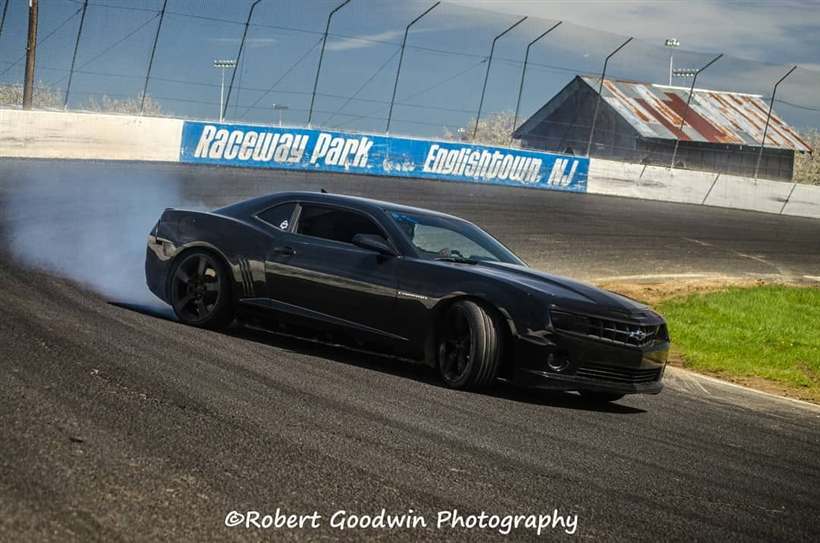 The Camaro laying smoke past the Raceway Park Englishtown NJ wall.